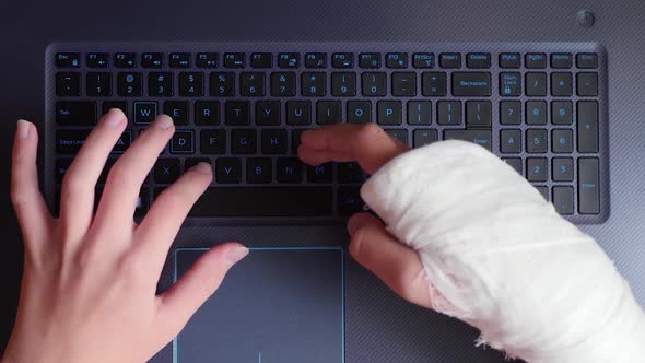 Broken Arm Typing on Keyboard