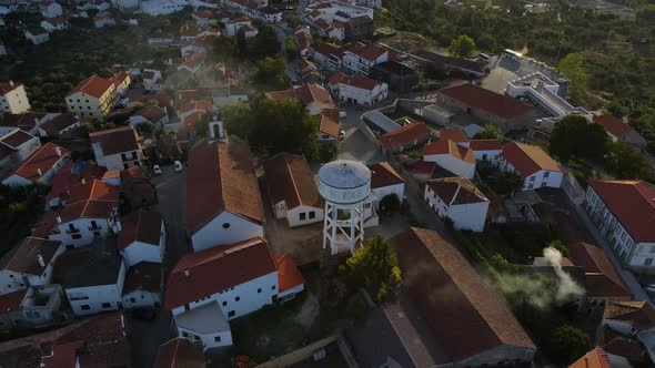 Drone flies over downtown Belmont seeing the local water tower and the orange tile rooftops alt