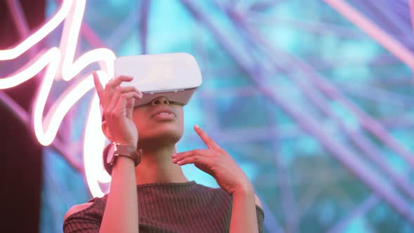 AfricanAmerican Woman Wears Virtual Reality Headset to Play