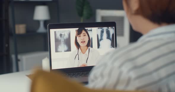 Asia girl using computer laptop talk about disease in video conference call with senior doctor.