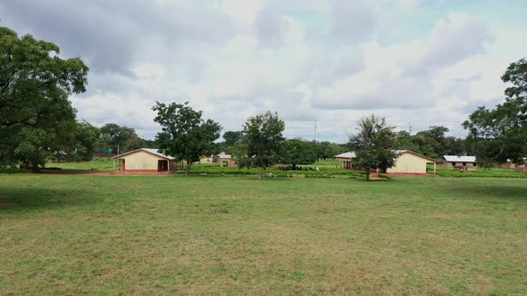 school compound in Africa with vegetation alt
