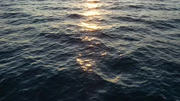 Flying on the surface of the sea. Seascape during sunset.  alt