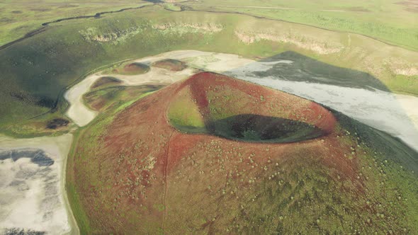 Dried caldera lake among bigger lake from air