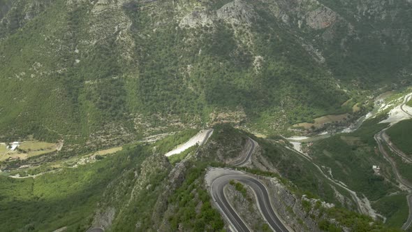Drone Rising Above Curvy Road Over Canyon Valley in Northern Albania