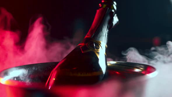 A Bottle of Expensive Champagne is Cooled in an Ice Bucket alt