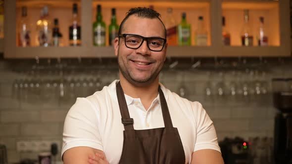 close-up portrait of a confident smiling bartender at the bar alt