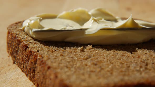 Spreading Vegan Butter on Rye Bread Without Dairy and Eggs