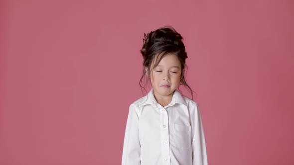 Cute Little Child Girl in White Shirt Shows Different Emotions on Pink Background