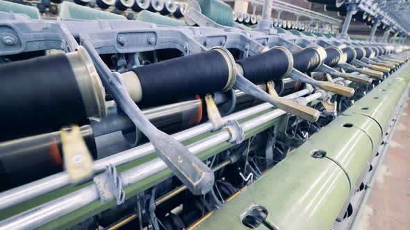 Sewing Spools are Revolving in the Textile Machinery alt