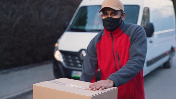 Courier Delivering Parcels During Covid19 Man Wearing Mask While Carrying Boxes alt