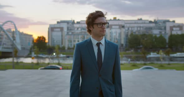 Medium Shot of Caucasian Businessman in Stylish Formal Wear Walking Outdoors alt