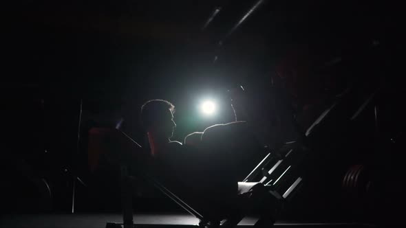 The Athlete Trains Legs in Exercise Machines - Leg Press. Professional Athlete Doing Leg Day Routine alt