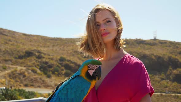 Blonde Model Looking at Parrot then Sideways alt