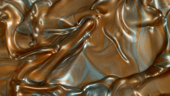 Super Slow Motion Shot of Silver and Golden Splashing Background at 1000Fps alt