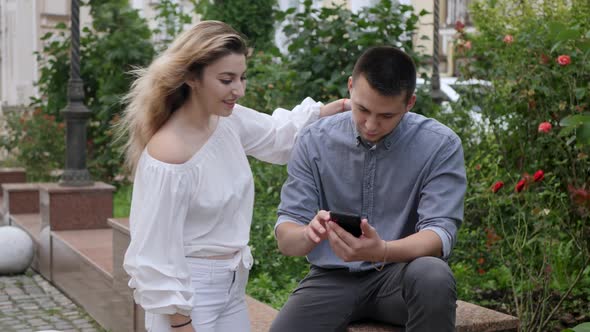 Couple Looks Into Phone