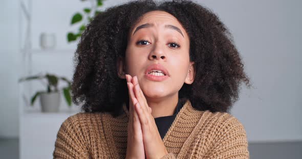 Cute Sly African American Black Woman Folds Her Hands in Request Pleading Makes Gesture of Apology alt