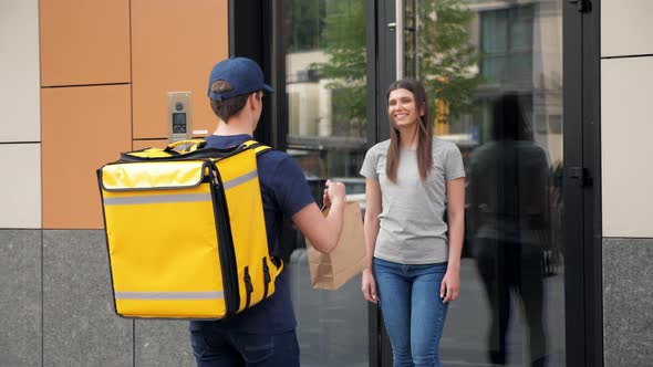 Positive Food Delivery Man Courier with Thermal Backpack Deliver Order Woman alt