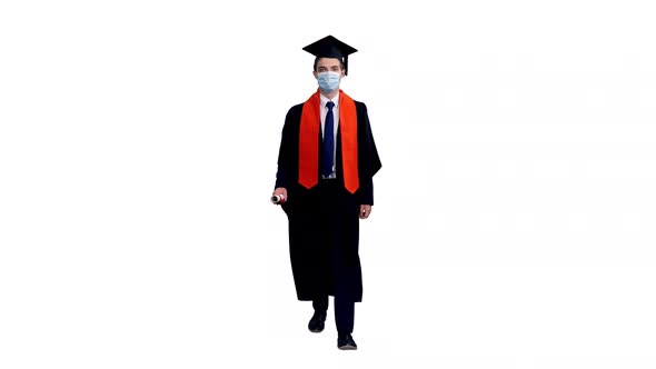 Graduating Student In Mask Walking And Showing His Diploma
