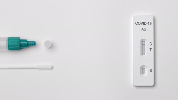 Positive result on rapid antigen test for COVID-19, top view of home test kit. alt