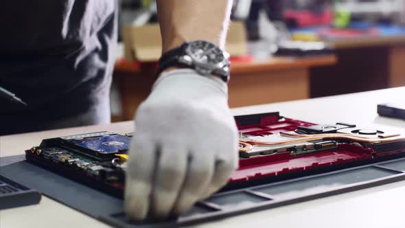 Professional Technician Detaches Laptop Hard Drive Ssd Repairing It in Workshop
