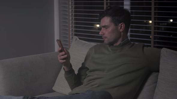 Man chatting via cell phone at night