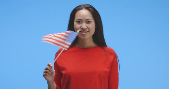 Young Woman Waving with Us Flag alt