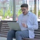 Man Celebrating Success on Laptop While Sitting Outdoor on Bench - VideoHive Item for Sale