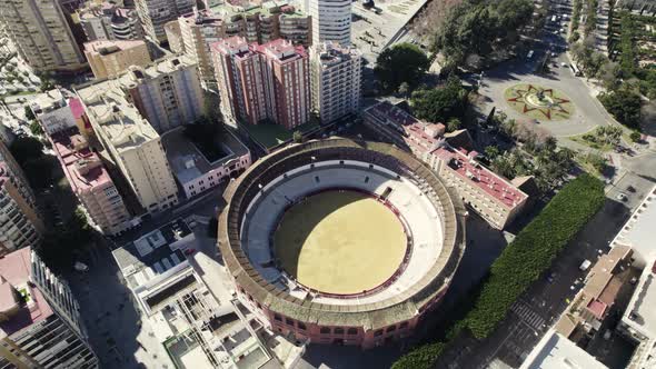 Plaza de Toros La Malagueta, Malaga bullring against cityscape, Spain. Aerial tilt up shot