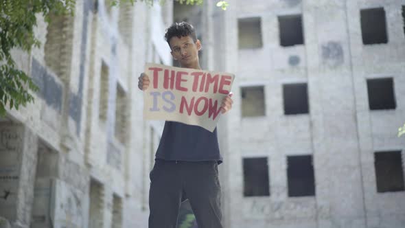 Young Serious Mixed-race Man Posing in Sunlight on Abandoned Urban Site. Portrait of Confident alt