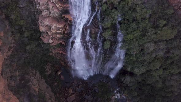Aerial view overhead a waterfall in a canyon