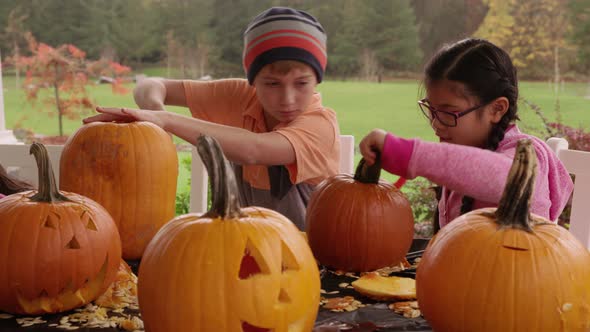 Kids carving pumpkins for Halloween