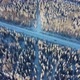 Aerial View From a Drone of a Road in the Middle of Snowcovered Trees and Snowcovered Forest on a - VideoHive Item for Sale