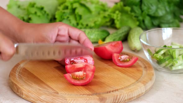 Woman hands cut fresh tomato, homemade food.