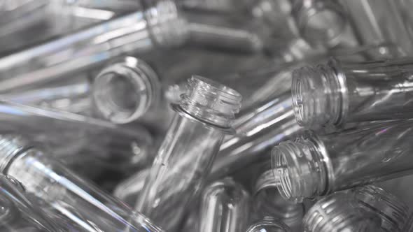 Small Plastic Blanks From Underwater Bottles Travel Along a Conveyor Belt