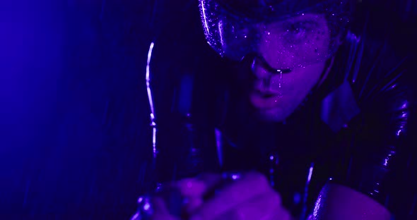 Triathlon Athlete Riding a Professional Racing Bicycle on an Intense Workout in Dark with Rain alt