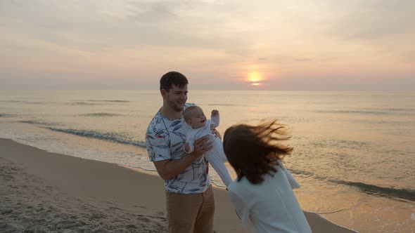 Young Family at the Sea Beach and Sunset
