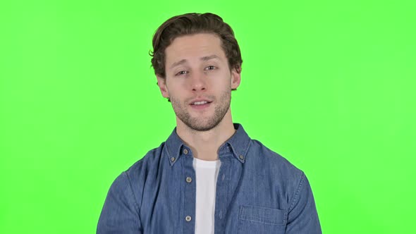 Young Man Pointing at Camera and Inviting on Green Chroma Key alt