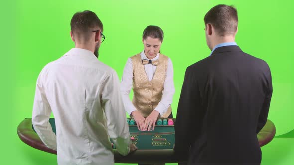 Croupier Woman Handing Out Cards and Chips for Two Players in Poker. Green Screen. Slow Motion alt