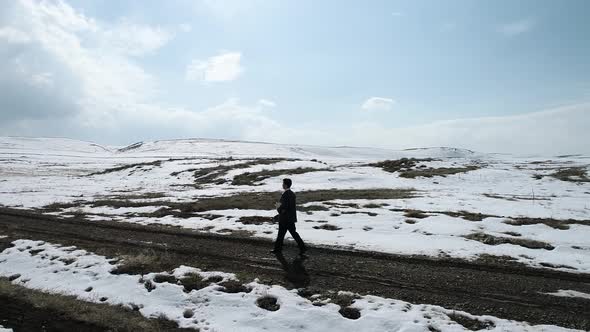 Young Man Walking The Village Road Aerial View alt