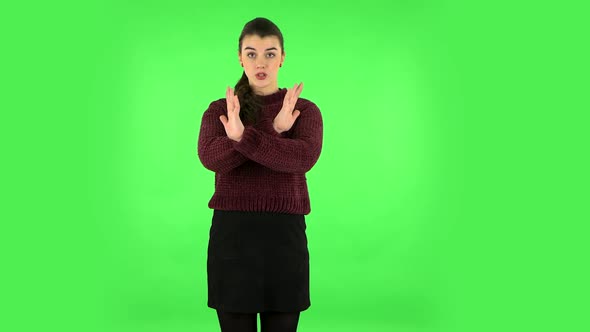 Woman Strictly Gesturing with Hands Crossed Making X Shape Meaning Denial Saying NO. Green Screen alt