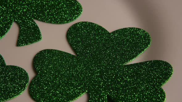 Rotating stock footage shot of St Patty's Day clovers on a white surface - ST PATTYS 006 alt