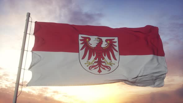 Brandenburg flag, Germany, waving in the wind, sky and sun background alt