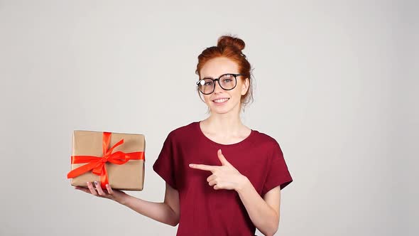 Attractive Girl Hold Gift Box in Hands.