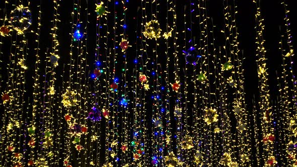 Beautiful Colorful Holidays Decorations, Garlands Sway on Wind in Night Sky.