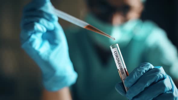 Doctor taking samples from coronavirus COVID-19 test tube