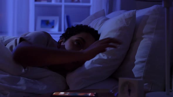 Sleeping Woman Awaking Because of Phone at Night alt