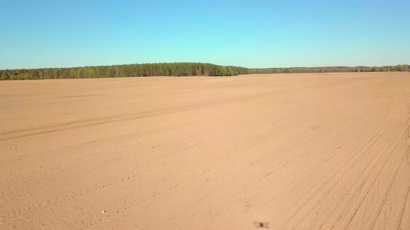 The Drone Flies Over a Plowed Field alt