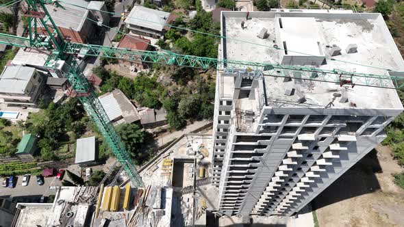 Working process on high building construction site. Construction of a residential buildings alt