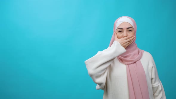 Muslim Woman in Hijab Removing Hand From Her Mouth in Studio Isolated