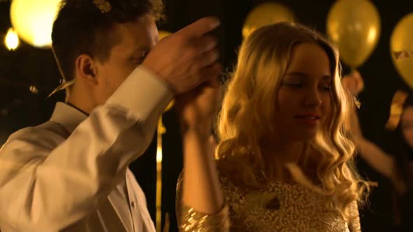 Nice Caucasian Couple Dancing Under Falling Confetti, Celebration Together alt